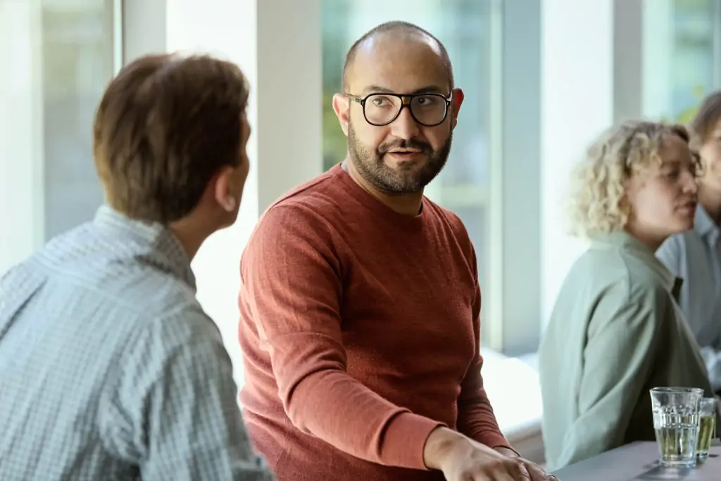 men sitting at the table and talking