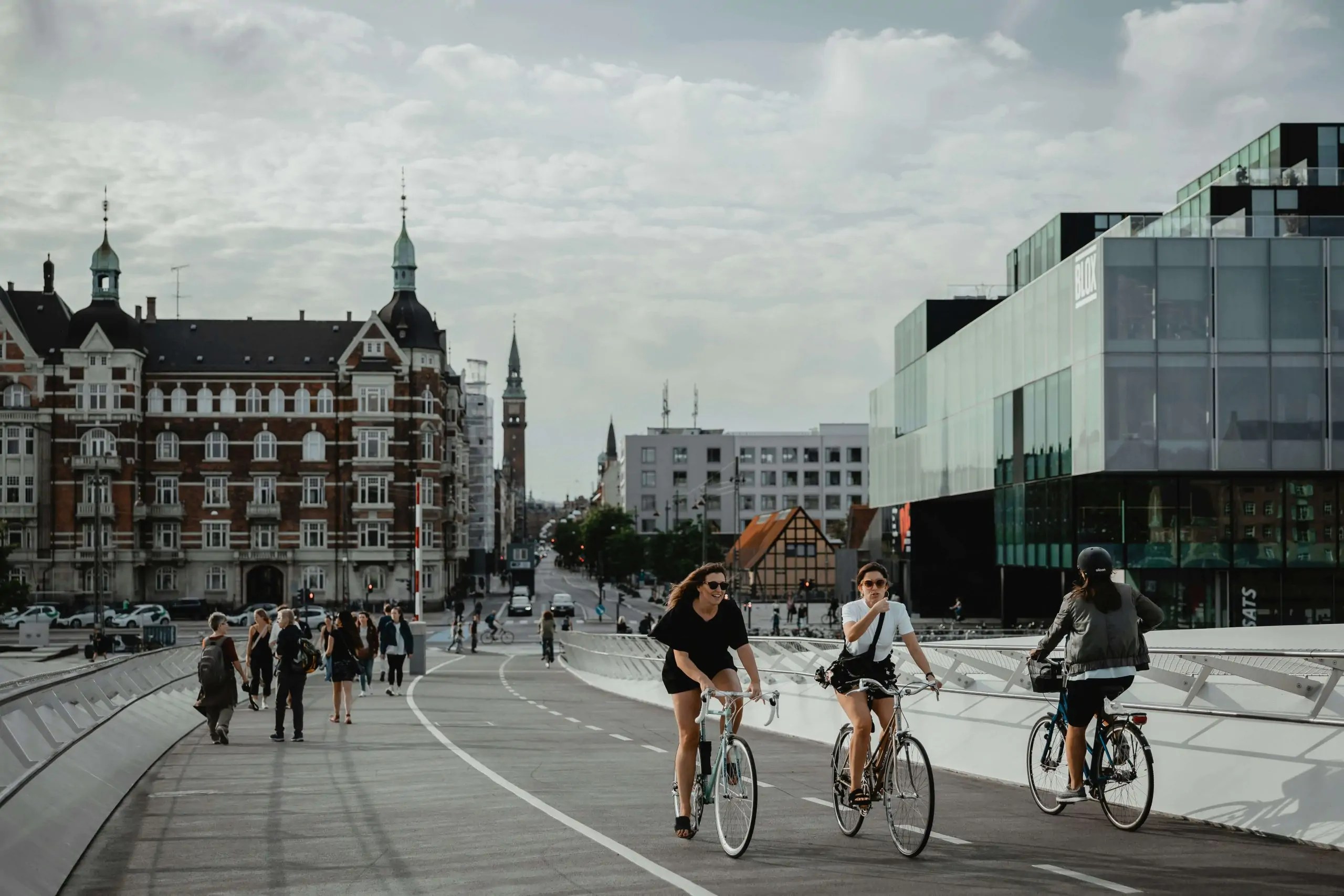 people cycling through the bridge in Copenhagen
